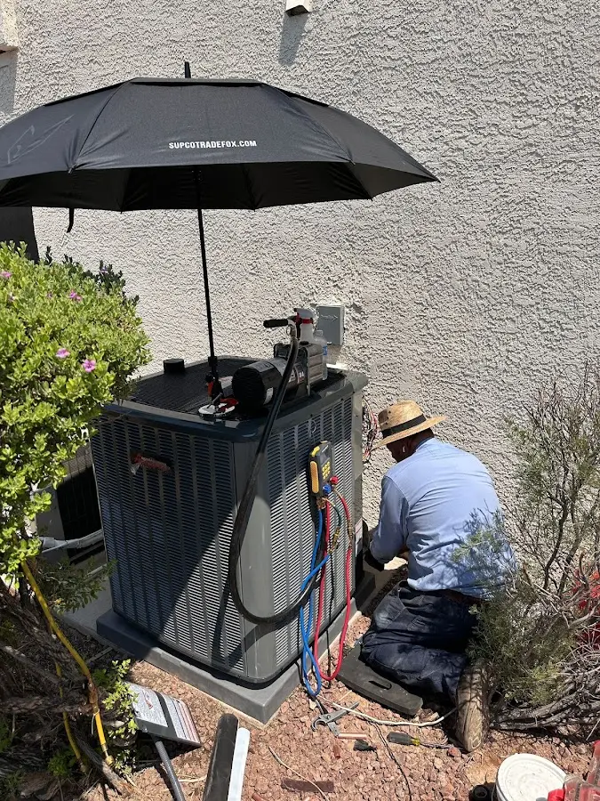 HVAC technician performing outdoor AC maintenance in Springtown