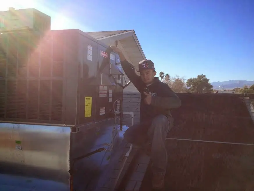 HVAC technician performing HVAC Inspection on a rooftop unit in Springtown